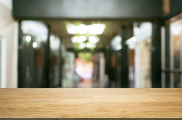 istock empty wooden desk over blurred coffee shop background 1140801064