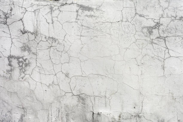istock Old dirty cracked grey and white wall texture background with stains,  divorces and peeling paint. 1140801172