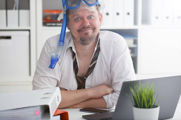 istock Man wearing suit and tie in goggles with snorkel 1140801732