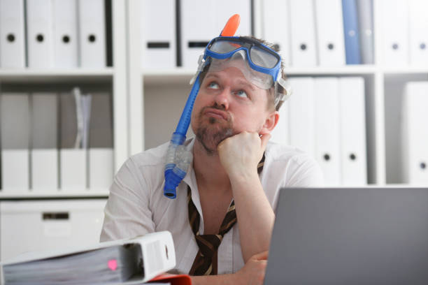 istock Man wearing suit and tie in goggles with snorkel 1140801733