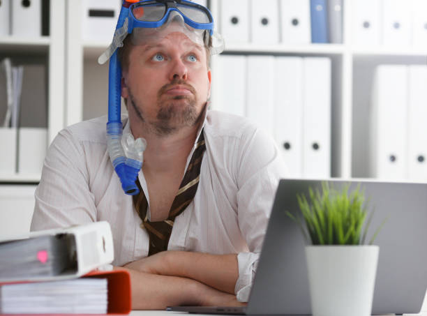 istock Man wearing suit and tie in goggles with snorkel 1140801737