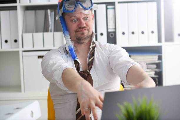 istock Man wearing suit and tie in goggles and snorkel 1140801751