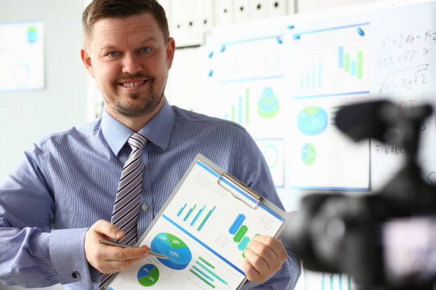 istock Male in suit and tie show stats graph pad 1140802227