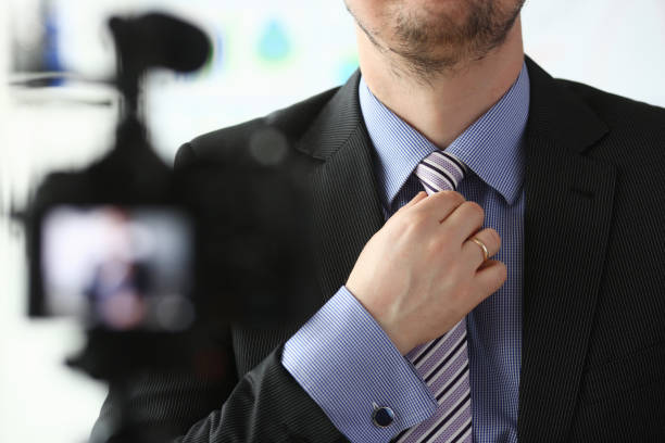 Male arm in blue suit set tie closeup on background web photo camera online show concept.