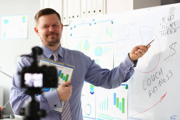 istock Male in suit and tie show stats graph pad 1140802317