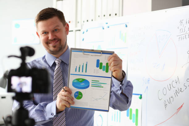 istock Male in suit and tie show stats graph pad 1140802318