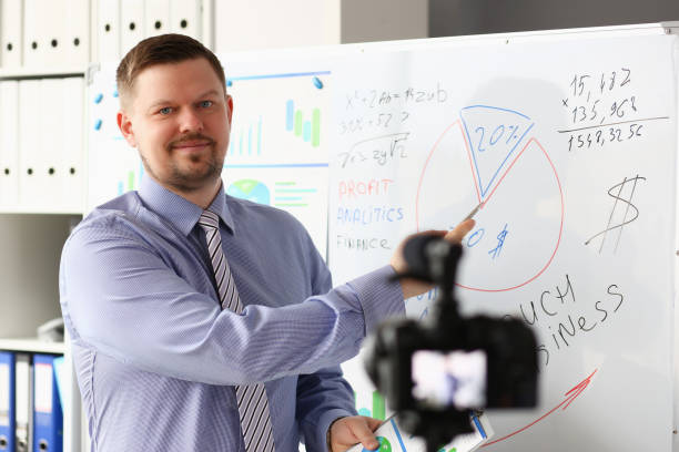 istock Male in suit and tie show stats graph pad 1140802324