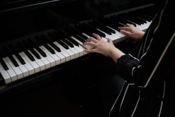 istock Beautiful asian girl learn to play piano. 1140802434