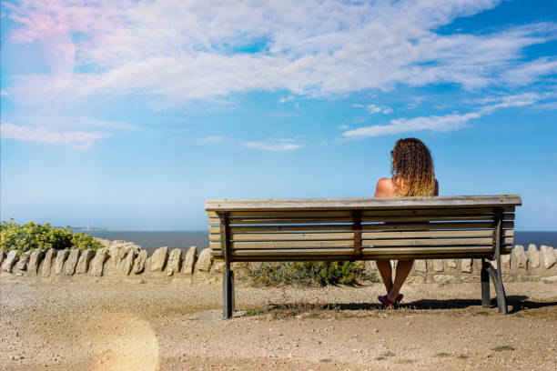 istock pretty woman looking at the sea 1140803213