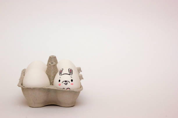 istock Easter rabbit painted on chicken egg in egg carton box 1140805478