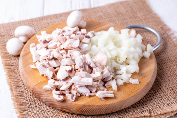 istock Sliced onions and champignons on a cutting board on a table 1140806993