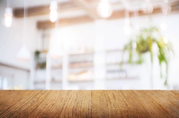 istock empty wood table over blurred montage coffee shop or kitchen background 1140808130