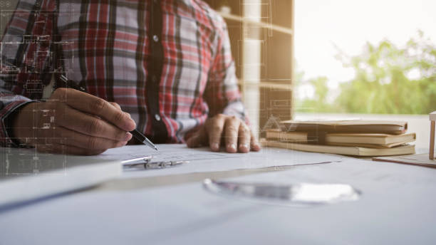 istock hands of man engineer working on blueprint with tools - interior architect concept 1140808152
