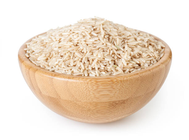 istock Brown rice in wooden bowl isolated on white background with clipping path 1140808542