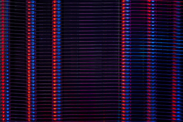 Ribbed metal surface of radiator in dual color light. Heating equipment. Grunge abstract background on the subject of industry, technology or architecture.
