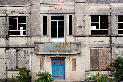 Close up view of broken window, broken glass, wooden window frame.