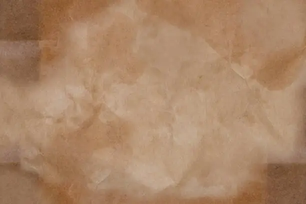 Crumpled and grease stains of kraft paper texture background. Crumpled and grease stains brown paper