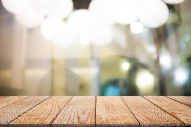istock blank wooden table with blurred montage coffee shop cafe background 1140815044