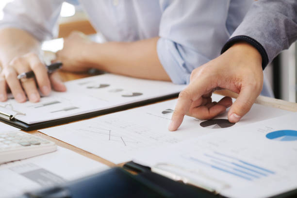 istock two businessman working together with financial report 1140815094
