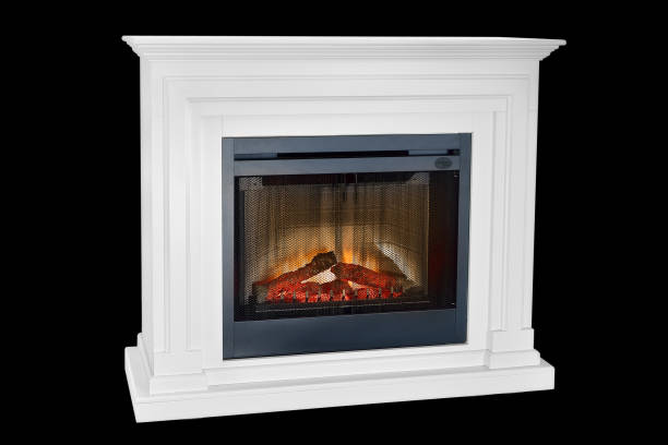 istock White wooden burning fireplace with roaring flames, classic elegant design. Isolated on black background, clipping path included. Fireplace as a piece of furniture 1140816332