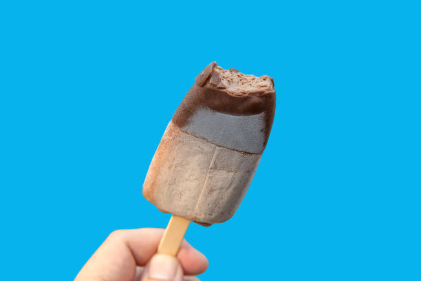 istock Popsicle sticks bite marks ice scream, die cut on blue background 1140819097