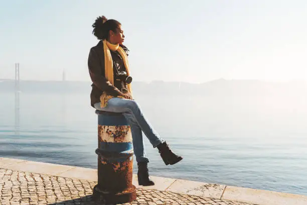 Photo of Biracial tourist girl on the quay