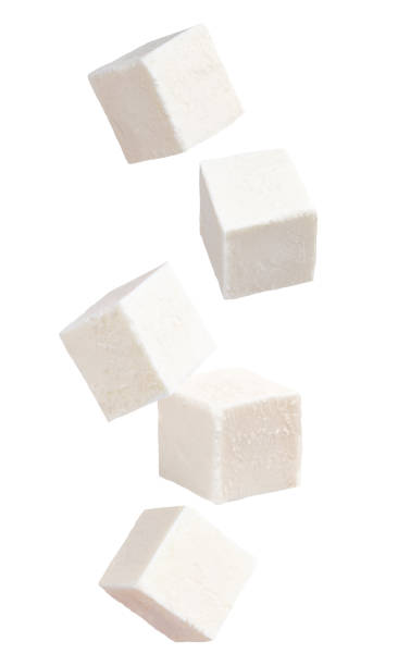 Falling cubes of soft cheese isolated on white background stock photo