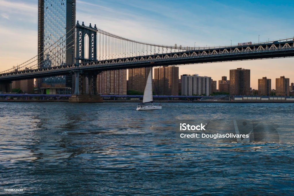 View of the Brooklyn bridge during a dusk from East river. New York City American Culture Stock Photo