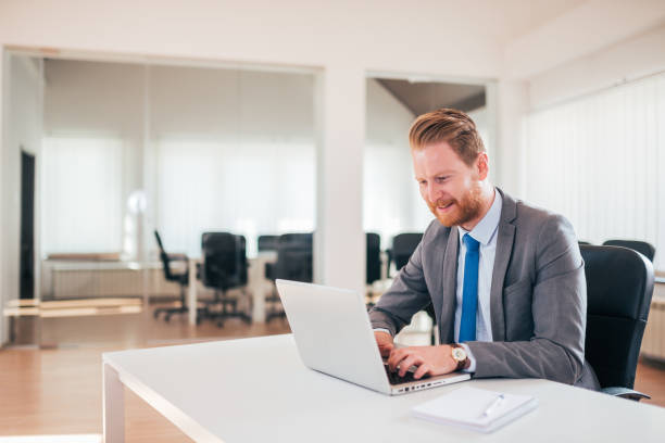 istock Redhead businessman working on laptop. 1140824003