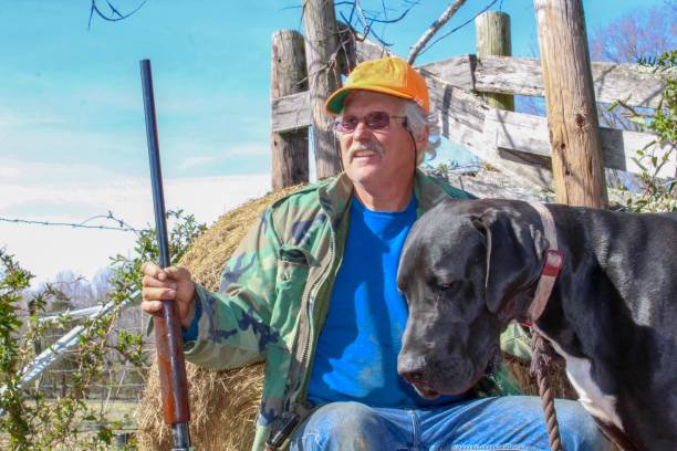 istock Active senior man with shotgun and dog hunting 1140824038