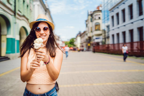 istock Young woman eating ice cream in a cone 1140824942