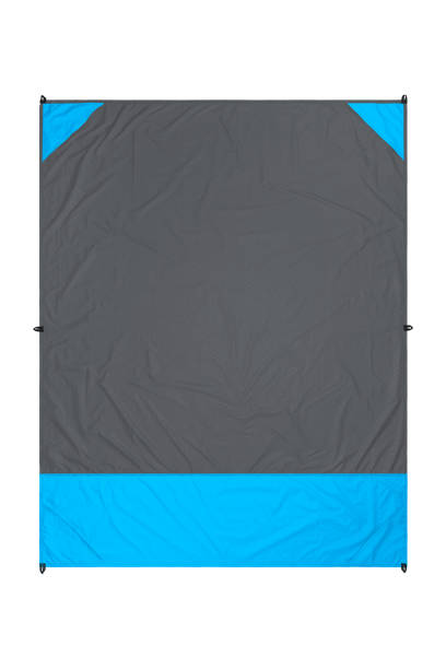 istock Gray and blue nylon beach blanket isolated on white background with visible corner pockets. Very thin and waterproof tarp or footprint for outdoor activities. Clipping path included. 1140825475