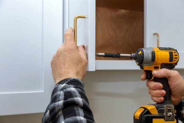 The installing a furniture handle process of assembling cabinet The installing a furniture handle process of assembling kitchen cabinet knob photos stock pictures, royalty-free photos & images