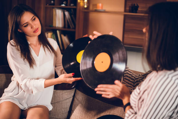 istock Two girls playing old records 1140828359