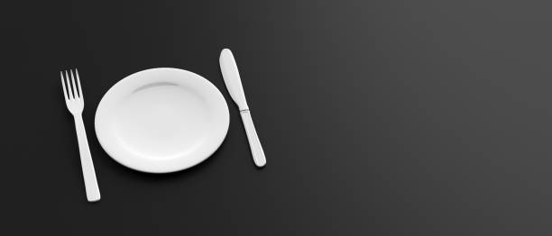 istock Empty white plate, fork and knife on black color background, banner. 3d illustration 1140828820