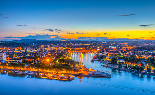 Night aerial view of confluence of Rhein and Mosel rivers in Koblenz, Germany