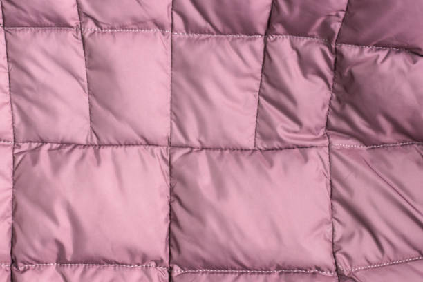 istock Textile and texture concept - closeup of crumpled pink fabric background 1140835575