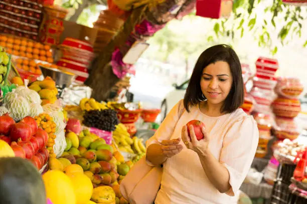 Photo of woman buying fruits at the farmer's market