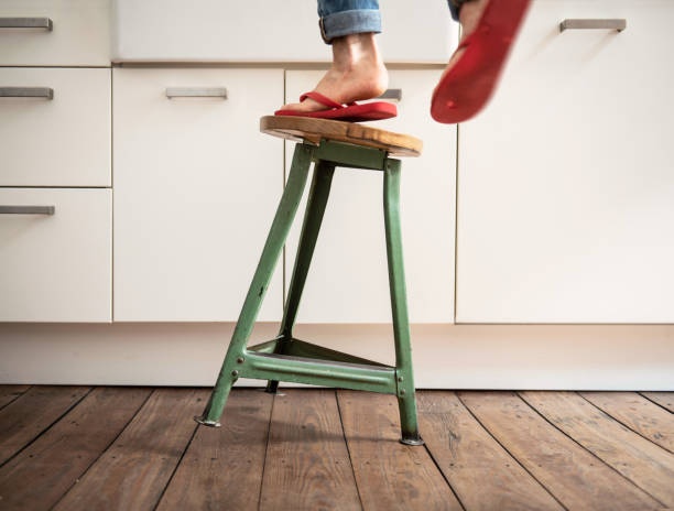 Dangers in the Household Man falls off stool hazard sign photos stock pictures, royalty-free photos & images
