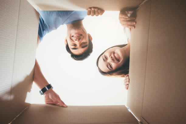 istock Happy young couple looking inside the box 1140837222
