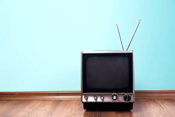 istock Retro old TV receiver on the table front gradient aquamarine wall background 1140840622