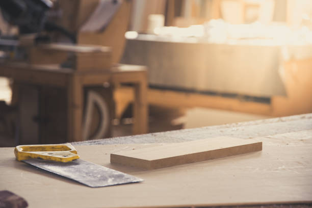 istock Metal saw for wood on carpenter workbench. Carpentry workshop. Carpenter tools. Sawdust. DIY concept 1140842004