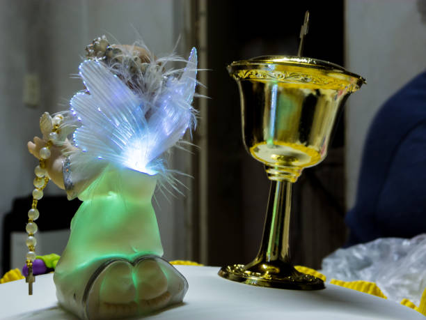 istock Angel ornament iluminated, with golden cup 1140842187