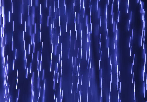 istock lines of light on a dark blue background 1140842272