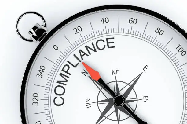 Photo of Compass Arrow Pointing to Compliance