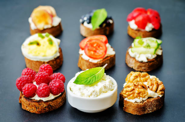 istock Ricotta and crostini appetizers with fillings on a black background 1140843998