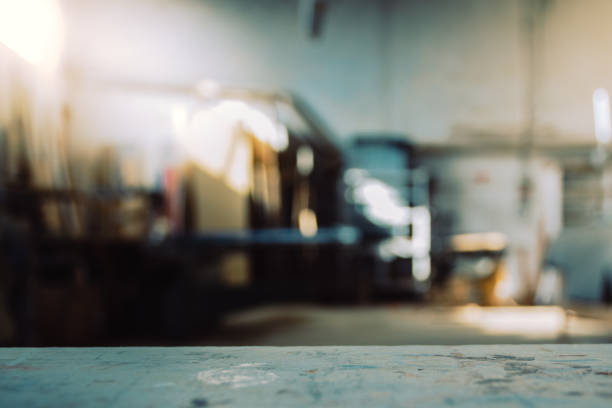 Blurred background of carpentry workshop. Copy space. Blurred background of carpentry workshop. Machinery background and table scratched stained table top. Copy space. woodshop stock pictures, royalty-free photos & images