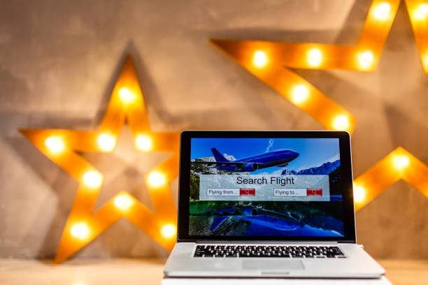 istock lights online booking and reservation. Search flights on a computer laptop screen, office desk background 1140845065