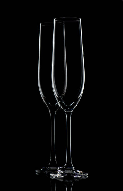 istock Two champagne glasses on black 1140845438