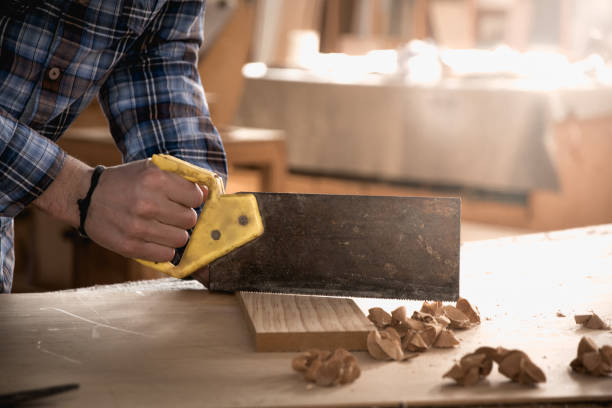 istock Carpenter working with saw on wood. Workshop background. 1140846733